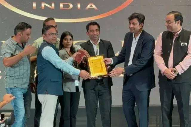 Chirag Arora receiving an award on stage at FC India